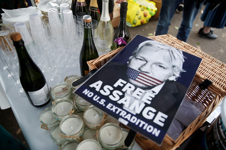 A view shows a placard depicting WikiLeaks founder Julian Assange, near bottles of sparkling wine belonging to his supporters, on the day of his and Stella Moris' wedding at HMP Belmarsh prison, in London, Britain, March 23, 2022. REUTERS/Peter Nicholls