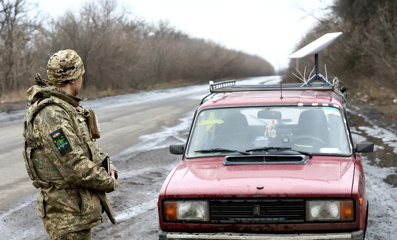 A Ukrainian serviceman stands next to a vehicle that carries a Starlink satellite internet system near the frontline, as Russia's attack on Ukraine continues, in Donetsk region, Ukraine February 27, 2023. REUTERS/Lisi Niesner
