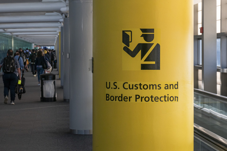 U.S. Customs and Border Protection CBP sign, inscription and symbol in yellow background in Newark Liberty International Airport EWR serving the New York Metropolitan area with arriving passenger walking in the terminal towards the immigration passport control. United States Customs and Border Protection is the largest federal law enforcement agency of the United States Department of Homeland Security with agents and officers, it's the primary border control organization. Newark, United States of America on November 2024 (Photo by Nicolas Economou/NurPhoto via Getty Images)