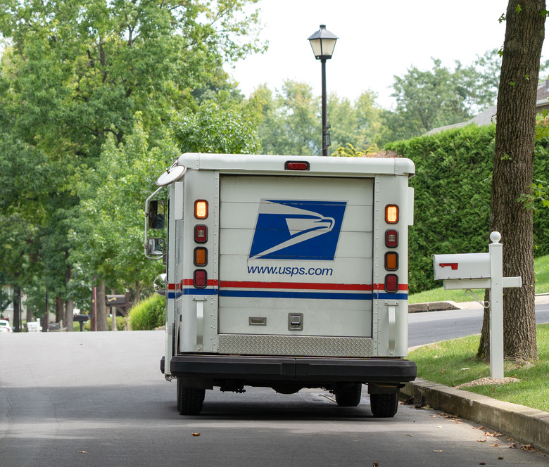 Berks County, Pennsylvania, USA-August 15, 2020: USPS truck delivering mail on suburban street in Pennsylvania.