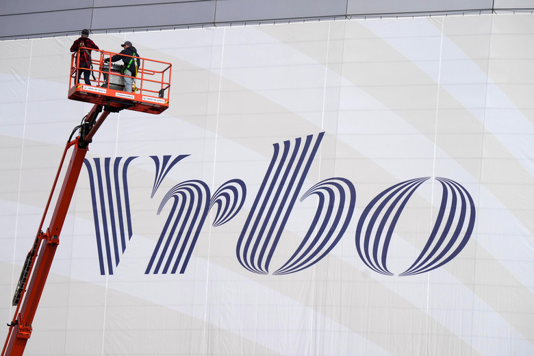 Dec 30, 2022; Glendale AZ, USA; Workers place Vrbo signage on the exterior of State Farm Stadium, the site of the 2022 CFP Semifinal between the TCU Horned Frogs and the Michigan Wolverines and Super Bowl 57 (LVII). Mandatory Credit: Kirby Lee-USA TODAY Sports