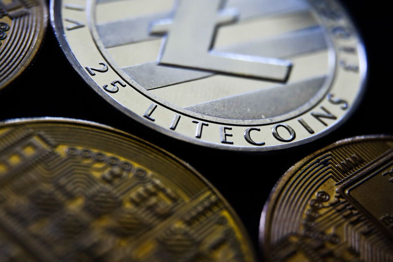 Representation of Bitcoin, Ripple, Litecoin and Ethereum cryptocurrencies is seen in this illustration photo taken in Krakow, Poland on June 6, 2021. (Photo Illustration by Jakub Porzycki/NurPhoto via Getty Images)