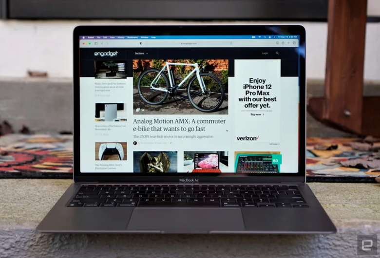 A laptop on a desk, open showing Engadget.