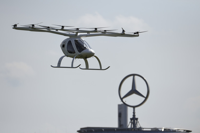 STUTTGART, GERMANY - SEPTEMBER 14: A Volocopter multirotor passenger aircraft takes off in front of the Daimler logo during the Vision Smart City event on September 14, 2019 in Stuttgart, Germany. Vision Smart City is a two-day event focusing on innovation around mobility of the future.  (Photo by Andreas Gebert/Getty Images)
