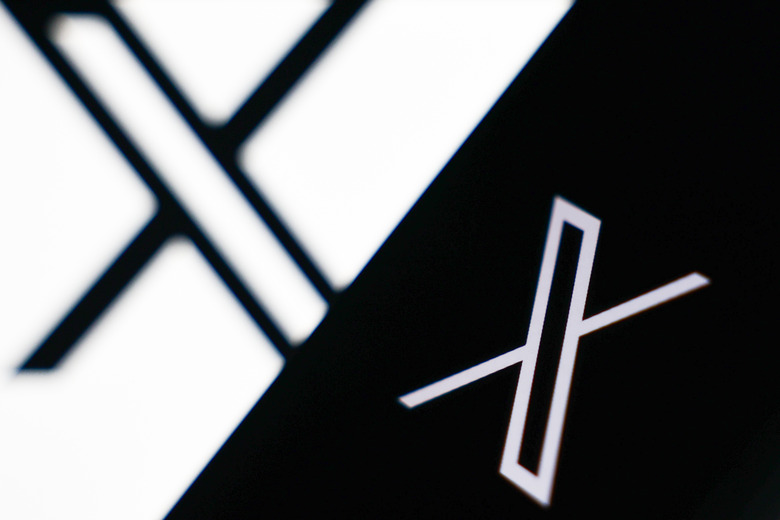 X logo displayed on a laptop screena and X logo displayed on a phone screen are seen in this illustration photo taken in Krakow, Poland on January 2, 2025. (Photo by Jakub Porzycki/NurPhoto via Getty Images)