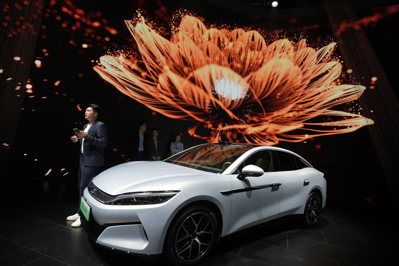 FILE - A man stands near the Han L EV model from BYD during the Shanghai auto show, April 23, 2025. (AP Photo/Ng Han Guan, File)