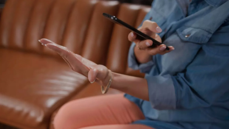 A smartphone reading a palm.