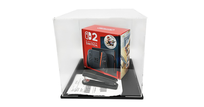 eBay auction photo of a punctured Switch 2 and a stapler
