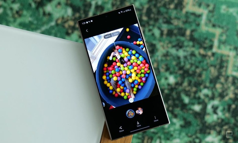 Photo of the Galaxy S24’s AI-based photo editing feature on the Galaxy S24 Ultra. A colorful ball pit is viewed in split screen before and after edits. The phone sits on the corner of a table.