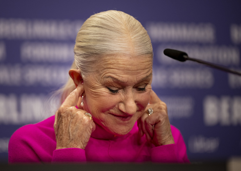 20 February 2023, Berlin: British actress Helen Mirren covers her ears at the press conference for the film 