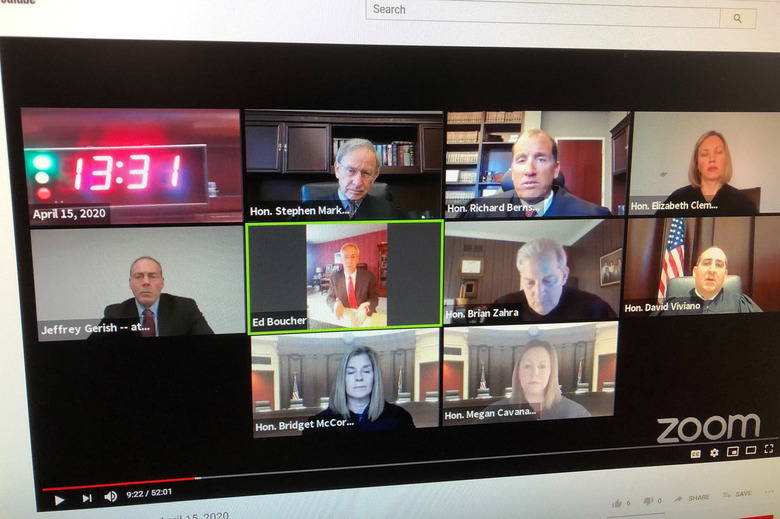 In this photo taken of a computer screen Wednesday, April 15, 2020, shows the Michigan Supreme Court who broke new ground by hearing two cases via Zoom video conferencing. Justice David Viviano was the only judge in his regular seat in court. At one point more than 180 people were watching live on YouTube. Justice Richard Bernstein, perhaps the most loquacious member, had questions for the lawyers as time was winding down. 