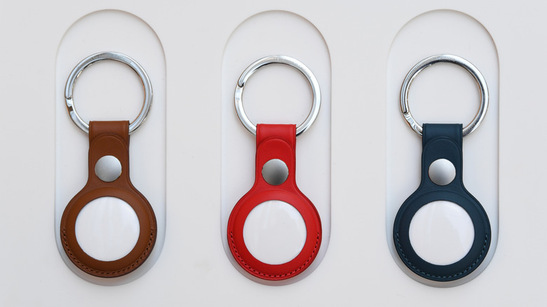Apple AirTags inside various-colored cases