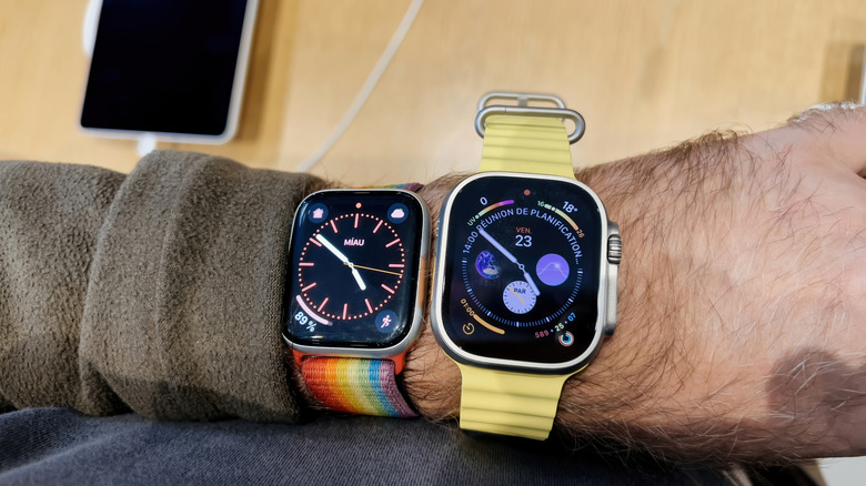 A wrist wearing an Apple Watch Series 8 and Apple Watch Ultra (first-gen)