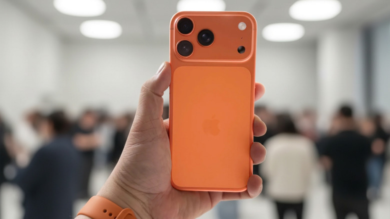 Orange iPhone 17 Pro held in hand