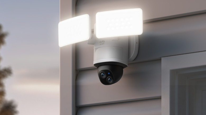 eufy Floodlight Camera E340 attached to outdoor wall with floodlights on.