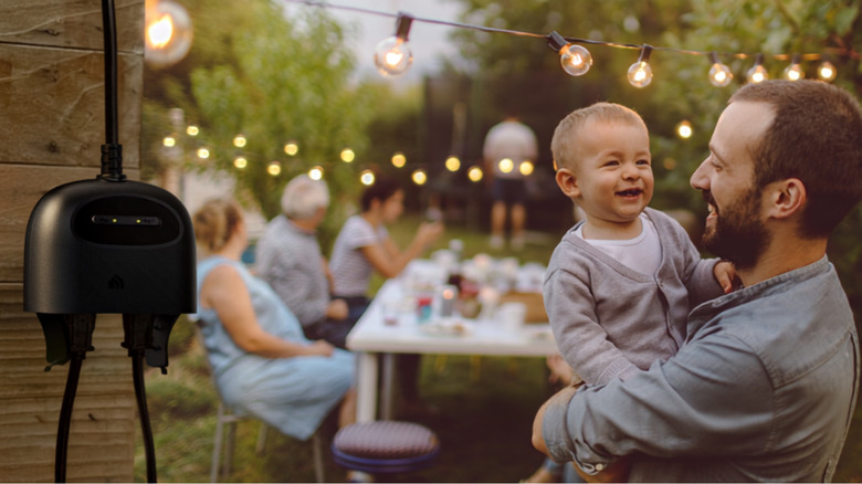 Kasa smart plug powering string lights outside as a family eats.