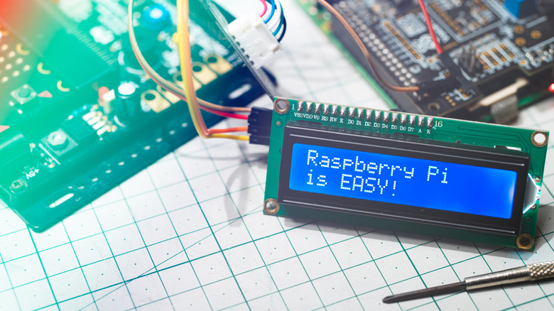 A blue LCD connected to Raspberry Pi hardware.