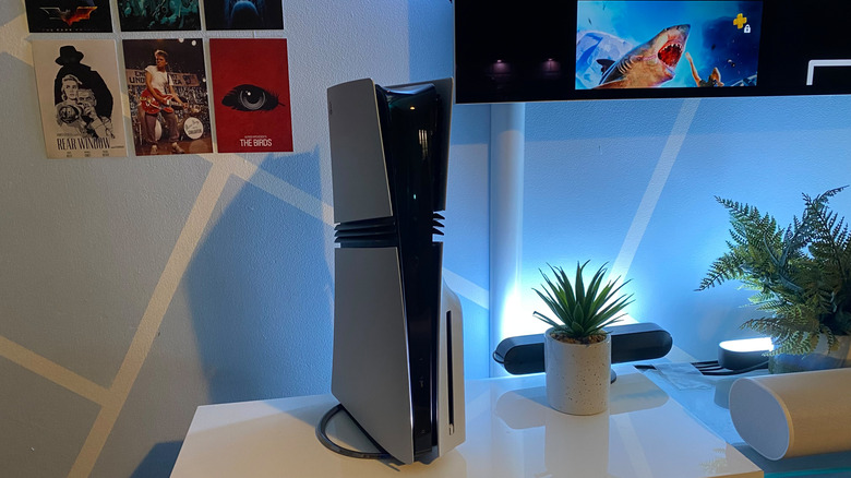 A PS5 Pro console on an entertainment stand, in a vertical position.