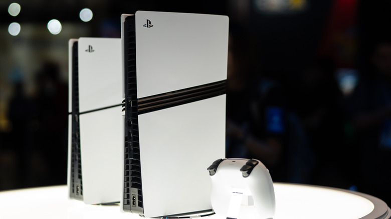 A PS5 Pro sitting to the right of the standard PS5 Slim at an event.