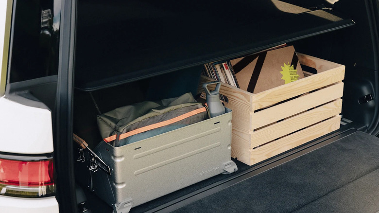The trunk of a Rivian R1S filled with crates.