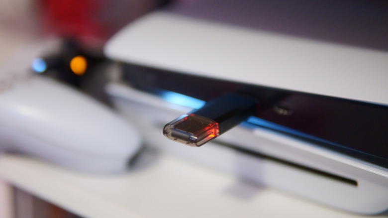 A USB flash drive plugged into a PS5 console.