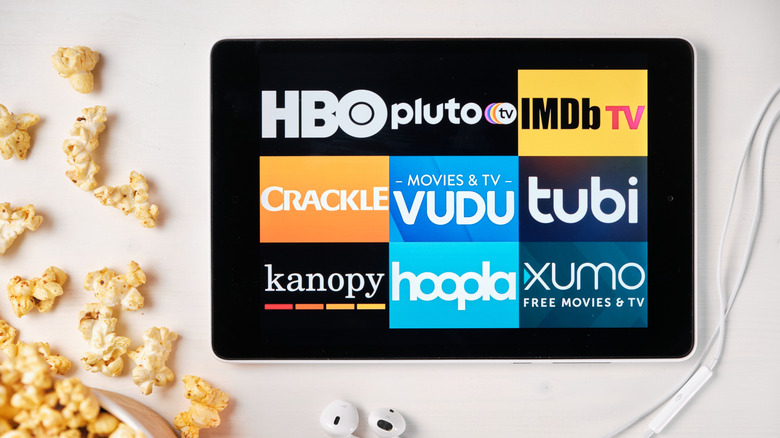 Various streaming service logos on a tablet, including Kanopy and Hoopla
