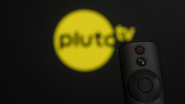 Pluto TV logo on a TV, with a remote in front of it