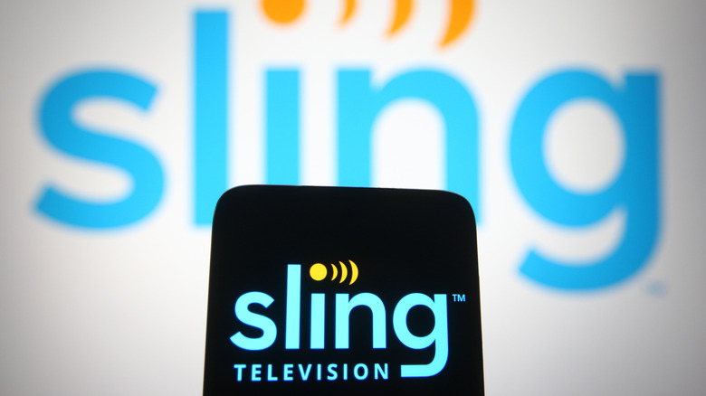 Sling logo on a phone in front of a TV also showing Sling
