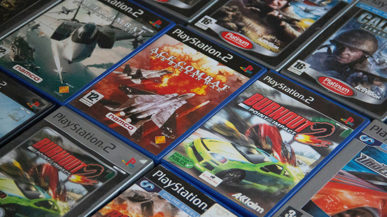PlayStation 2 game boxes lined up in neat rows. Several Burnout and Ace Combat games.