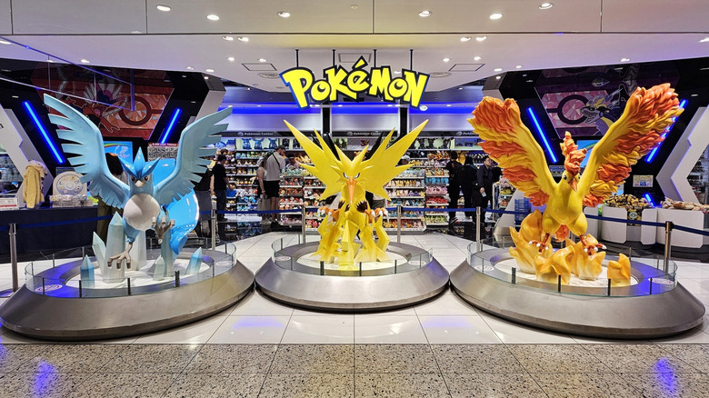 Pokémon statues at the entrance of a Pokémon store.