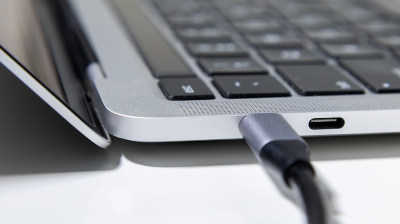 Close-up of USB-C cable plugged into Apple MacBook