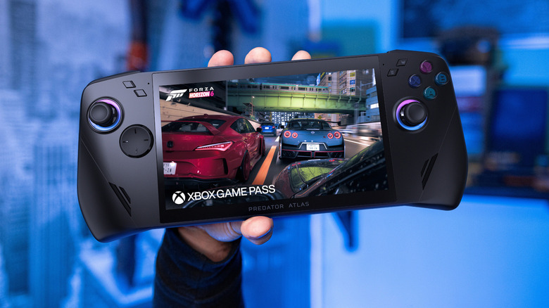 A hand holding a gaming handheld device aloft