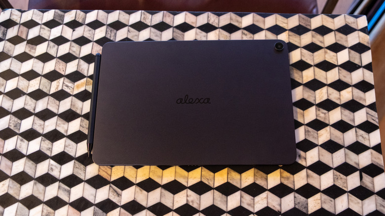 The back of the Alexa Tablet 12 Pro with the option pen accessory sitting on a table.