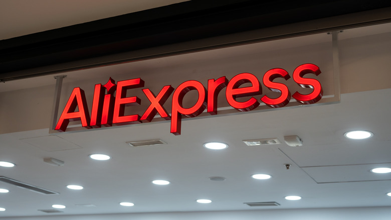 An AlieExpress red neon sign in shown at an outlet in Spain