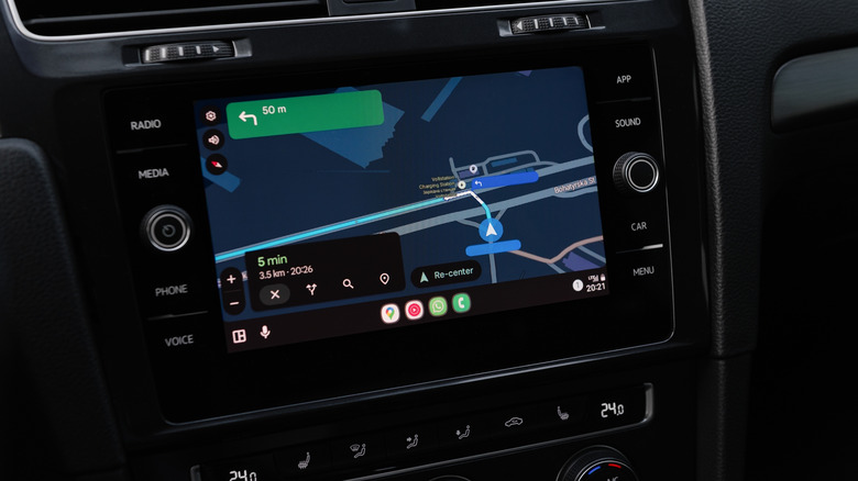Google Maps route instructions in dark mode on a car screen using Android Auto