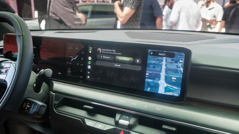The infotainment screen of a Kia EV displays Android Auto's Gemini smart replies feature.