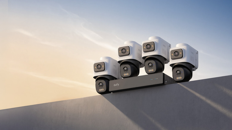 Photo of cameras from the Eufy NVR Security System E50. Four security cameras with a white housing for the top lens and a black housing for the bottom lens.