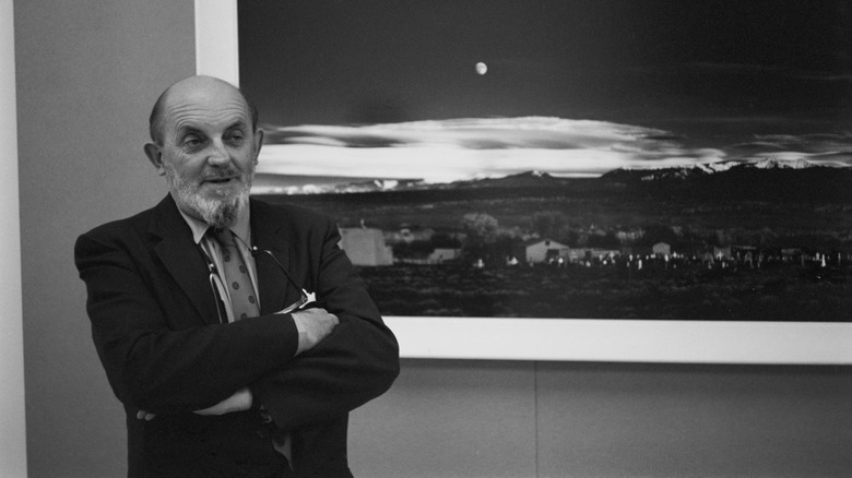 Ansel Adams pictured in 1941 beside his famous photograph, Moonrise, Hernandez, New Mexico