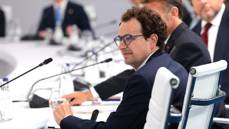 Dario Amodei, CEO of Anthropic, is shown at a press conference next to French president Emmanuel Macron
