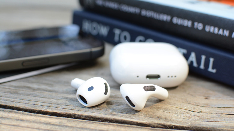 The AirPods 5 sitting outside of the case.