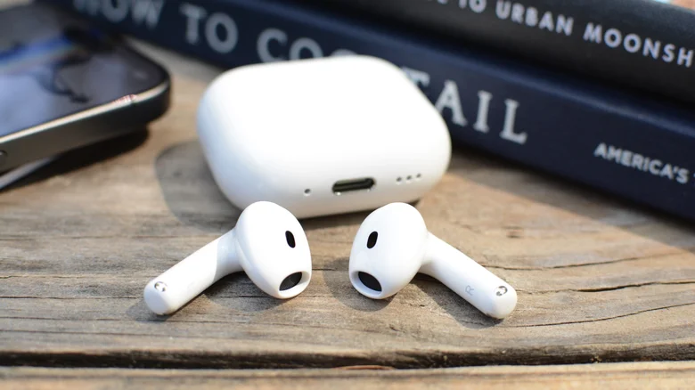 The AirPods 5 sitting outside of the case.