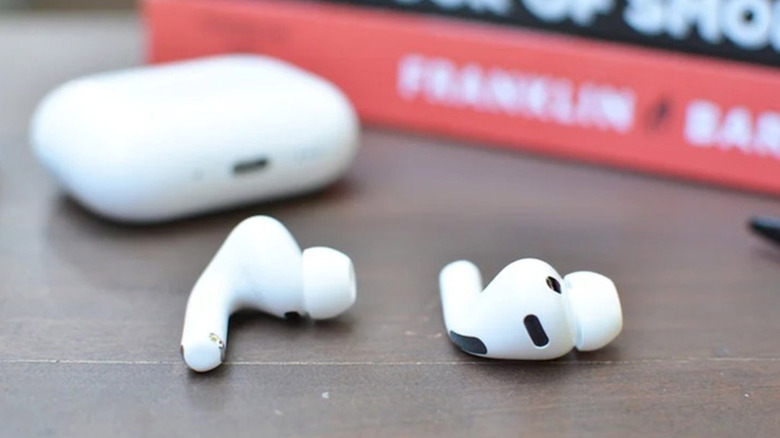 Apple's current-generation AirPods Pro are shown next to a book