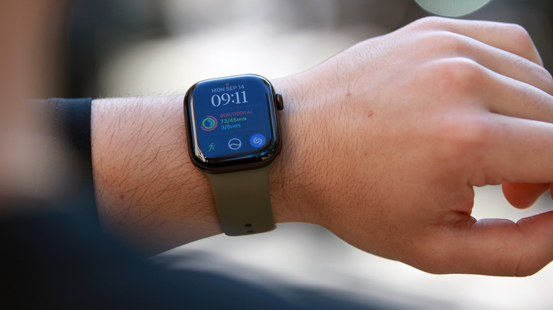 An Apple Watch Series 12 on a wrist held in mid-air.