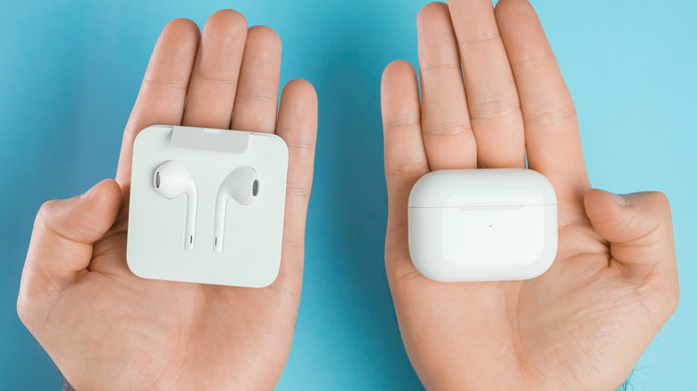 Apple's EarPods side by side with the AirPods charging case.
