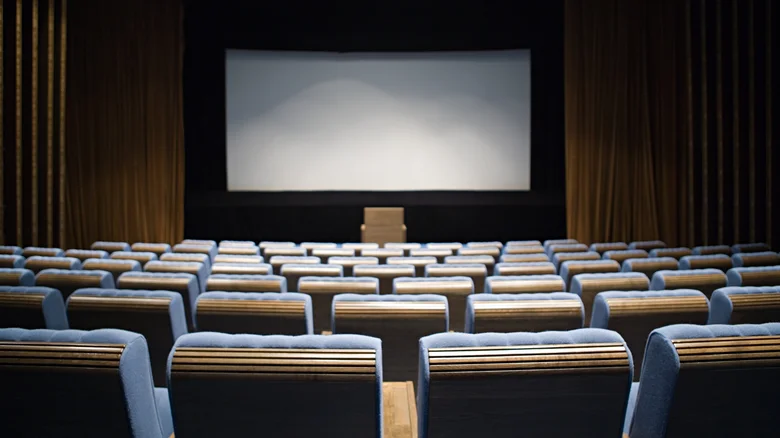 A mockup of a movie theater, showing seats facing a cinema screen.