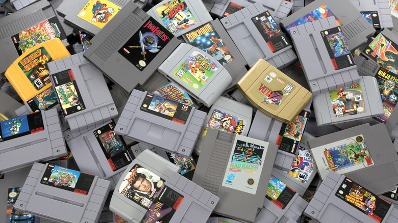A collection of old game cartridges seen from above in a pile