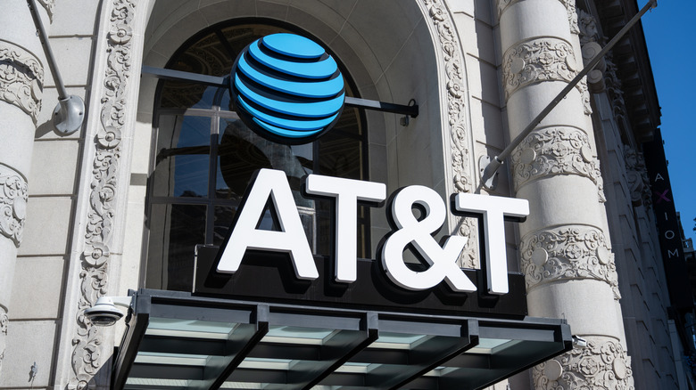AT&T sign with logo is shown in a store with an ornate facade