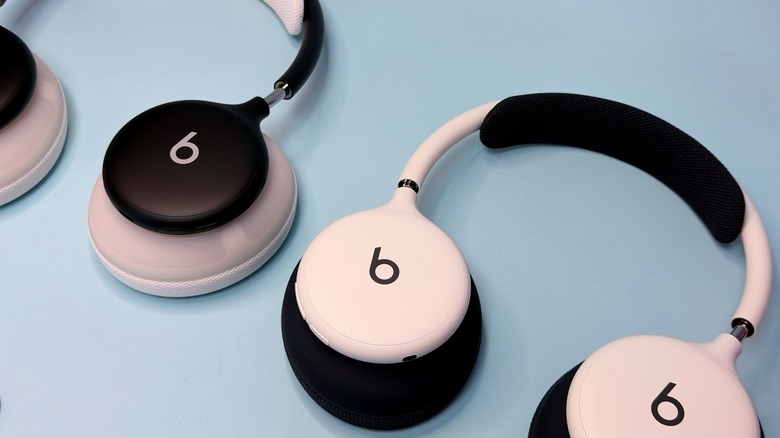 Beats 360 headphones with interchangeable ear cushions. Black and white pairs in the photo.