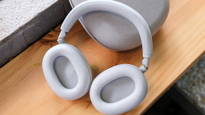 White Sony WH-1000XM6 headphones resting on top of their carrying case.