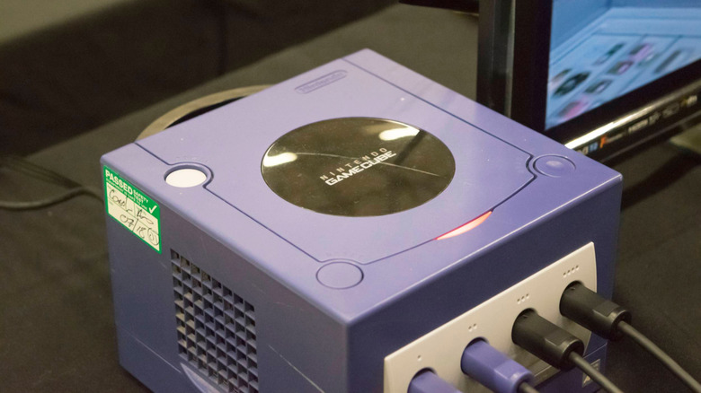 A GameCube plugged in next to a TV.